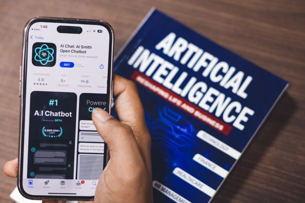 How to Prompt AI Properly: 10 Rules for Nigerian Professionals A phone showing an AI chat assistant beside a book on artificial intelligence