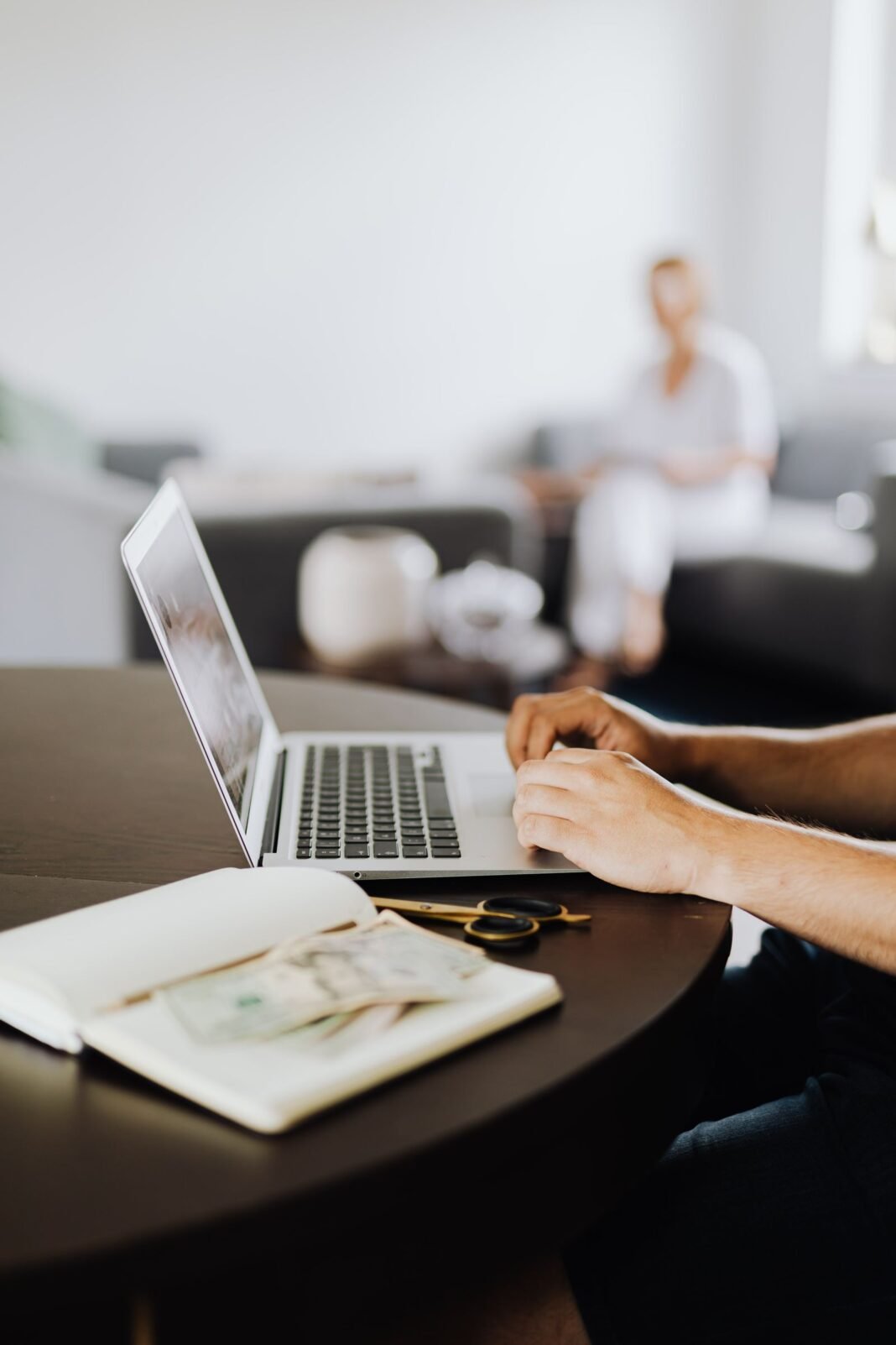 Remote Work from Nigeria: 9 Ways to Land Better-Paying Roles Hands typing on a laptop at a tidy home desk, working remotely
