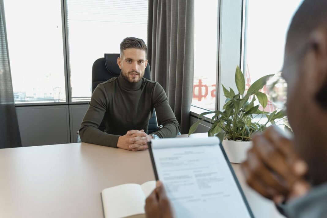 Job Hunting in Nigeria: 10 Ways to Get Noticed Faster A candidate meeting an interviewer across a desk during a job interview