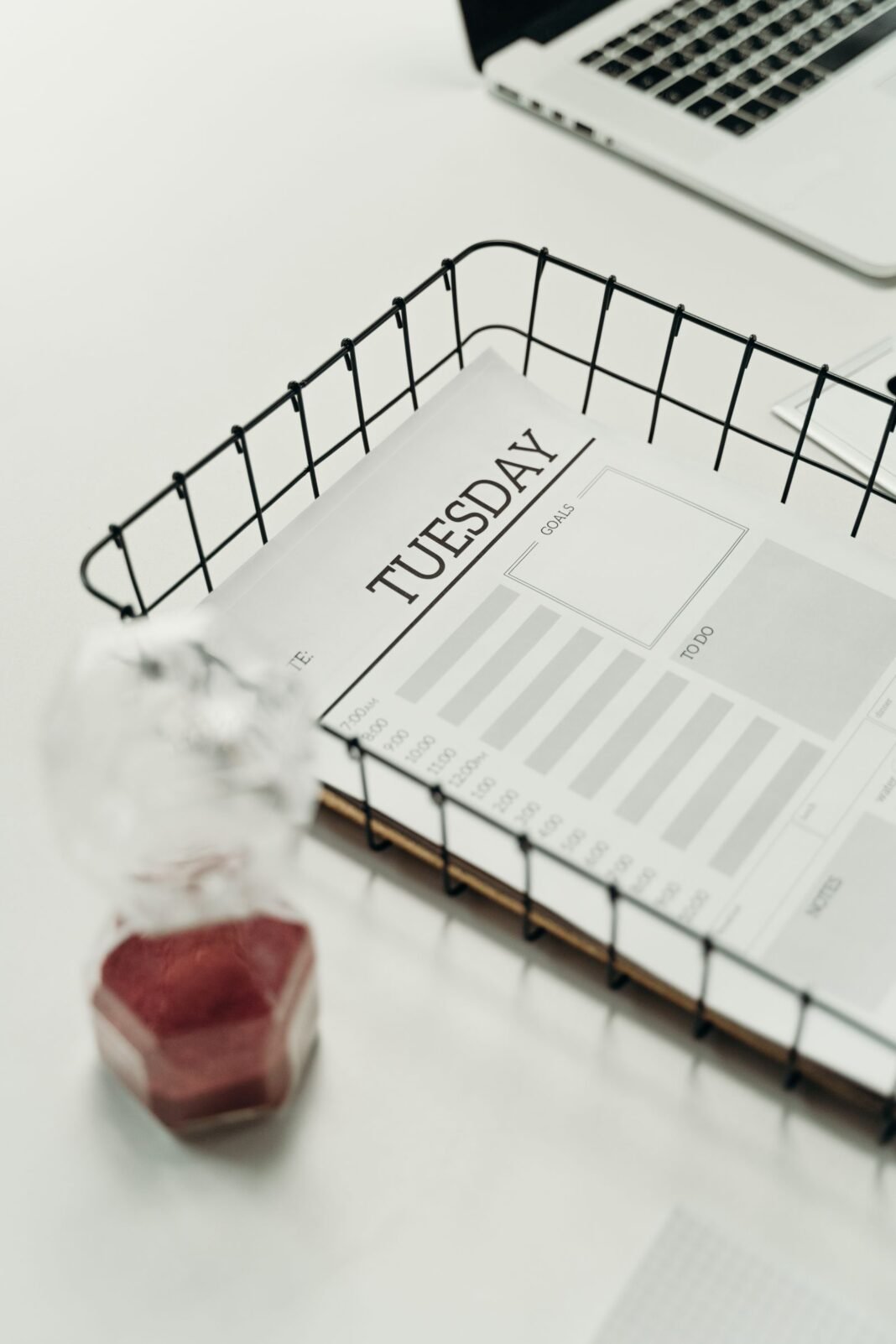 Time Management for Nigerians: 10 Rules to Take Back Your Day A weekly planner page open to Tuesday with a pen, used to plan the day