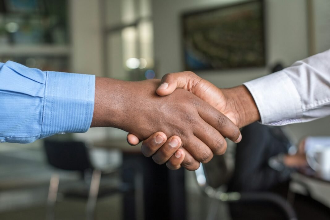 Leading With Integrity: Why Trust Is a Leader’s Greatest Asset Two people shaking hands, symbolising trust and integrity