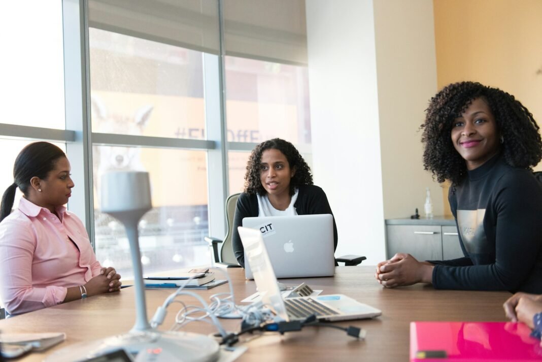 How to Prepare for a Job Interview: A Step-by-Step Guide Candidate speaking with interviewers around a table in a bright office