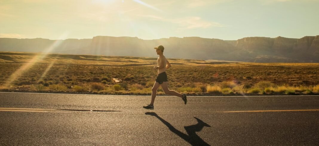 How to Build Resilience: Bouncing Back From Setbacks Runner on an open road at sunrise, representing resilience and perseverance