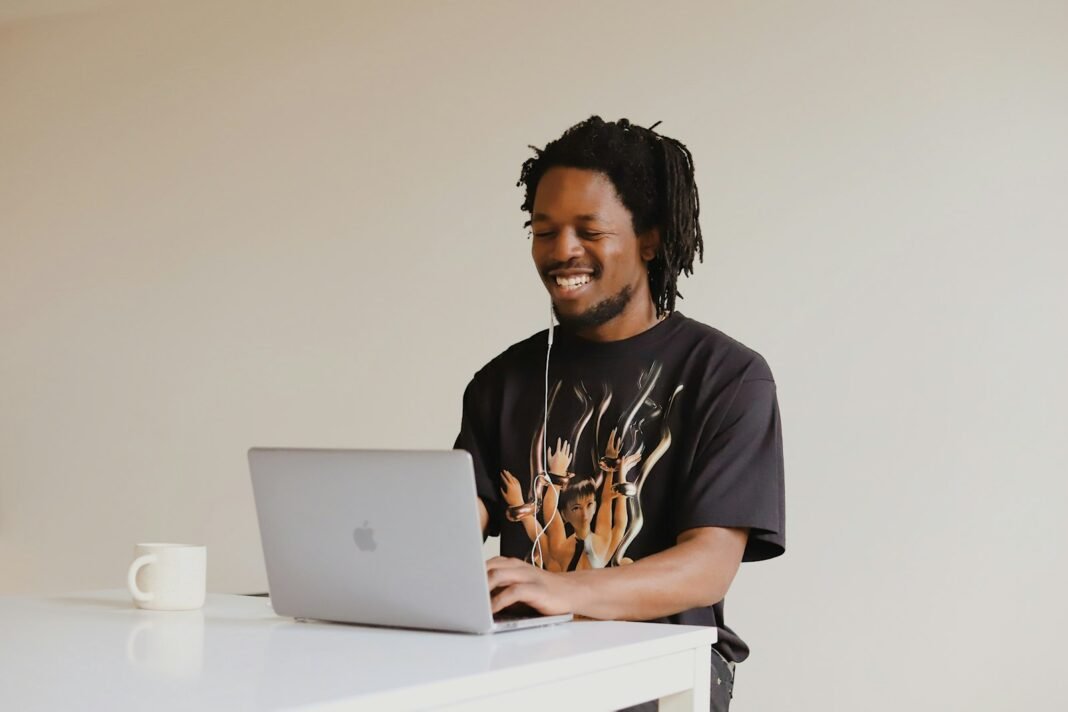 Man working with focus on a laptop at a clean desk