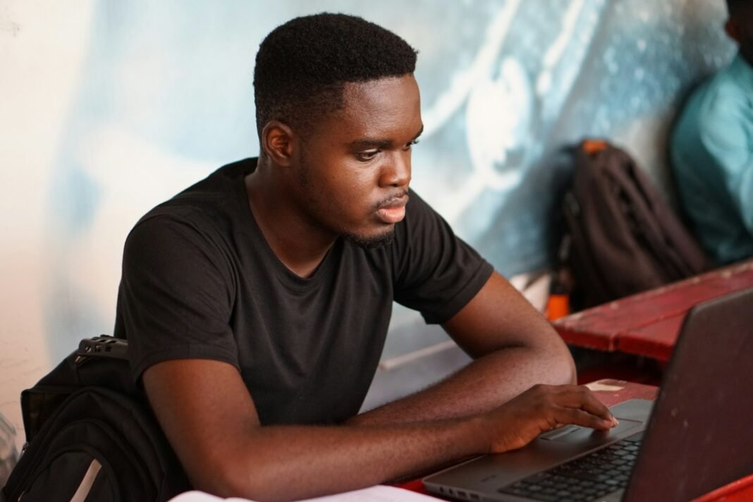 No Budget? These Free AI Tools Can Still Help You Study and Work Smarter Young Black student concentrating while using a laptop