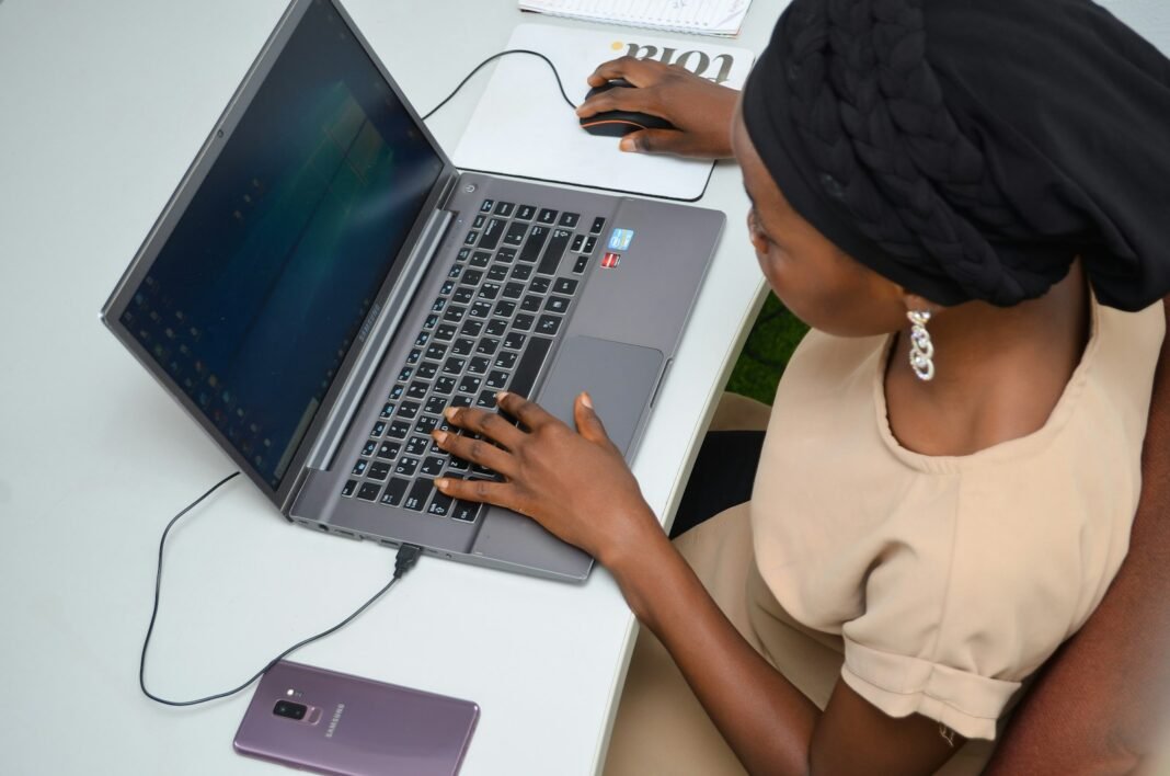 New Graduate? Learn Practical AI in 30 Days, Without Paying for a Course Young Nigerian woman learning on a laptop at her desk