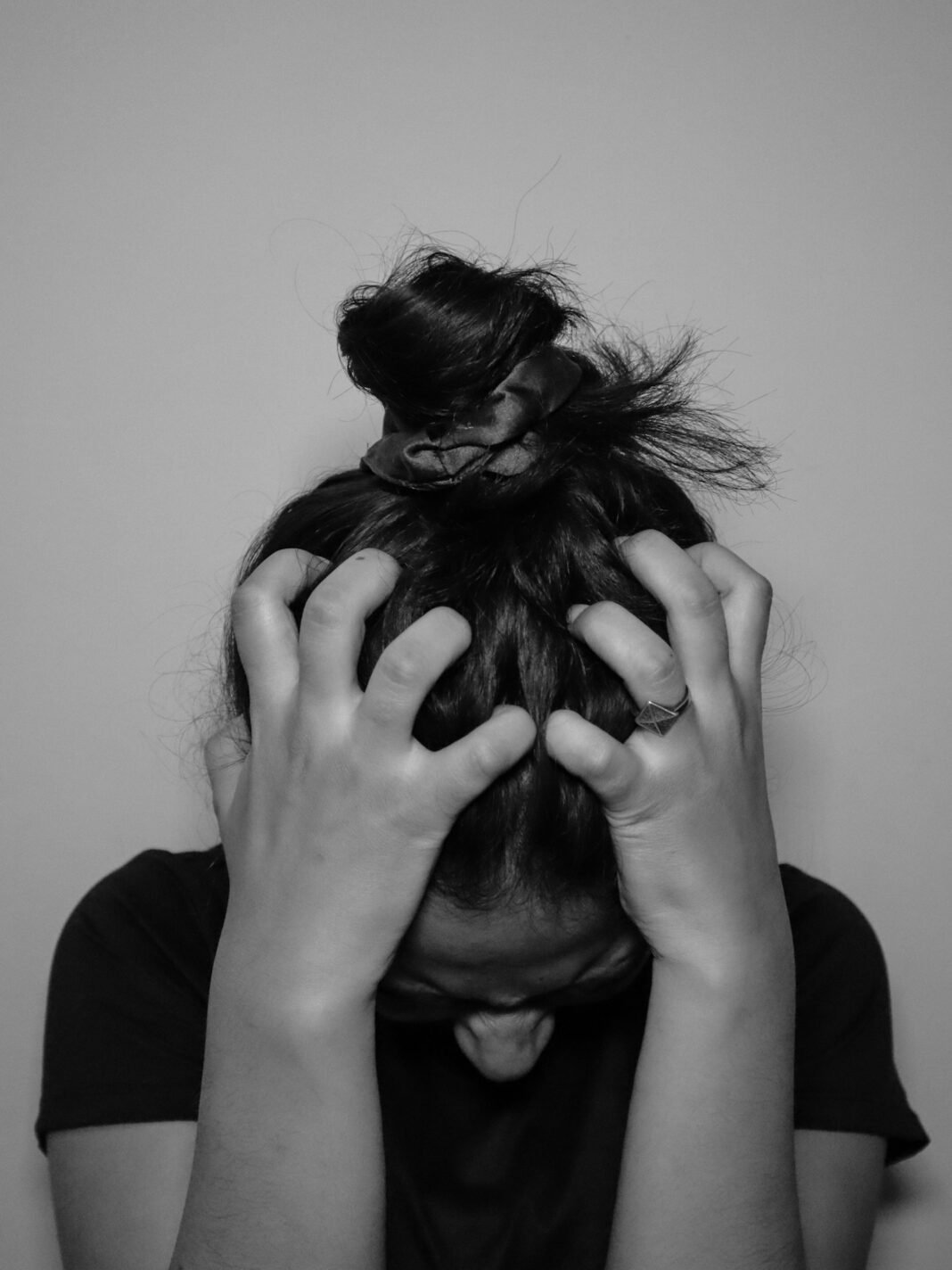 Person holding their head in their hands, feeling stressed