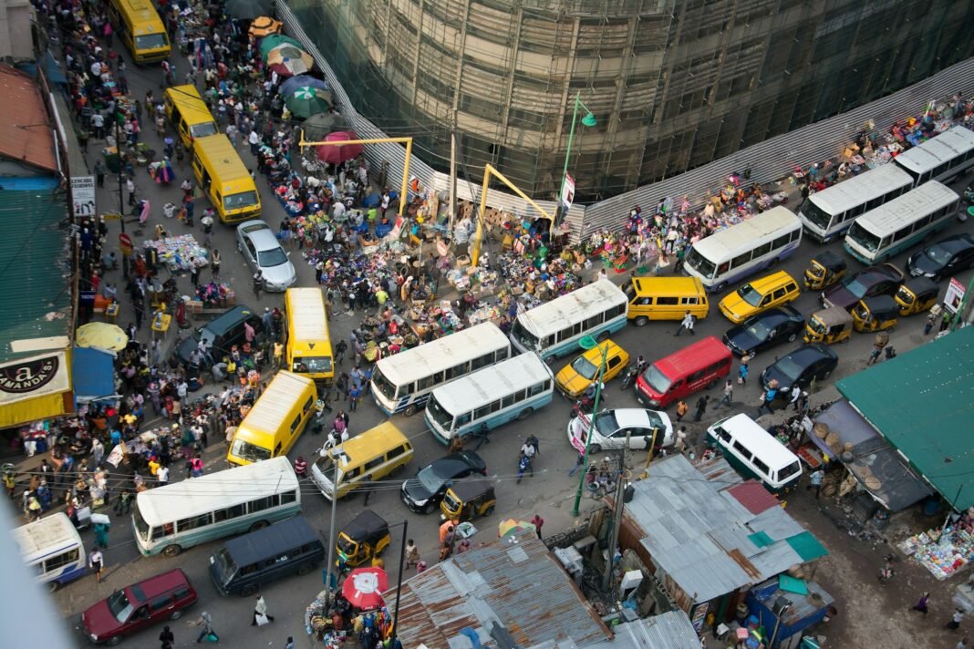 Busy Lagos street filled with traffic and yellow buses