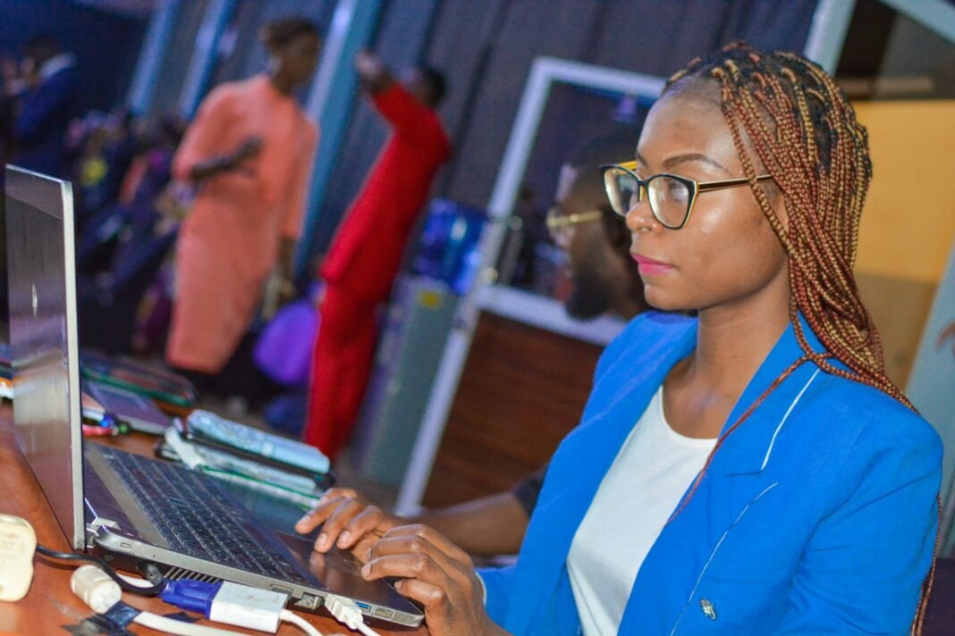Young Black woman in glasses working on a laptop as a freelancer
