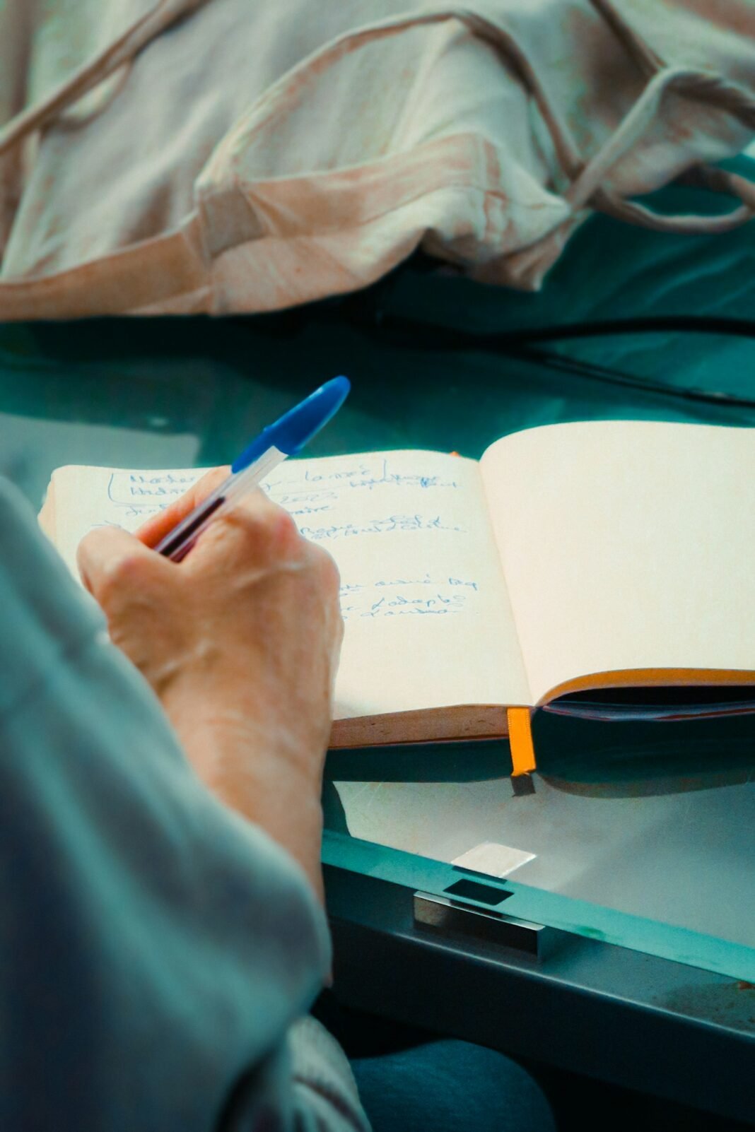 Person writing in a notebook while learning, illustrating a growth mindset