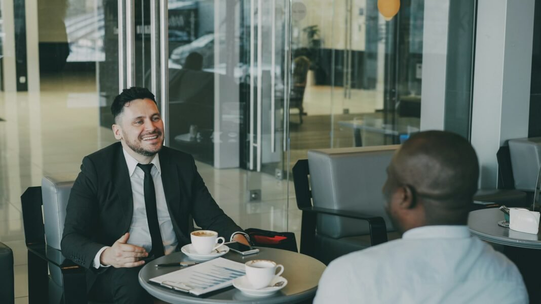 How to Give Feedback That Helps People Grow Two colleagues in a one-on-one conversation over coffee