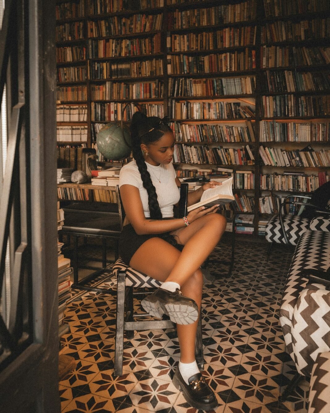 How to Build a Reading Habit (Even If You Are Busy) Young woman reading a book in a library